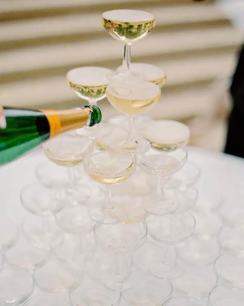Champagne cascading down a crystal coupe tower
